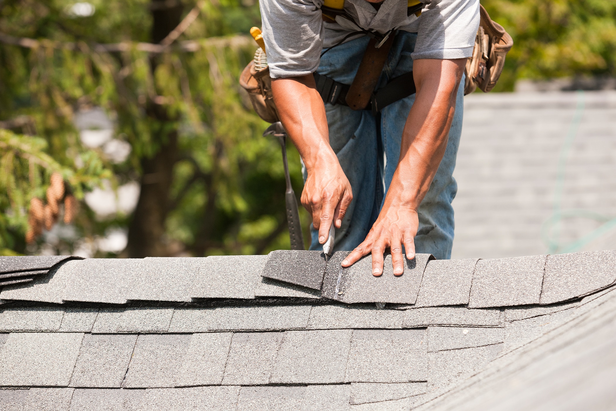 Man Cutting Roofing Cap Doing Roof Repair