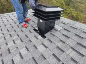 Tailored Home Improvements inspecting an attic ventilation point