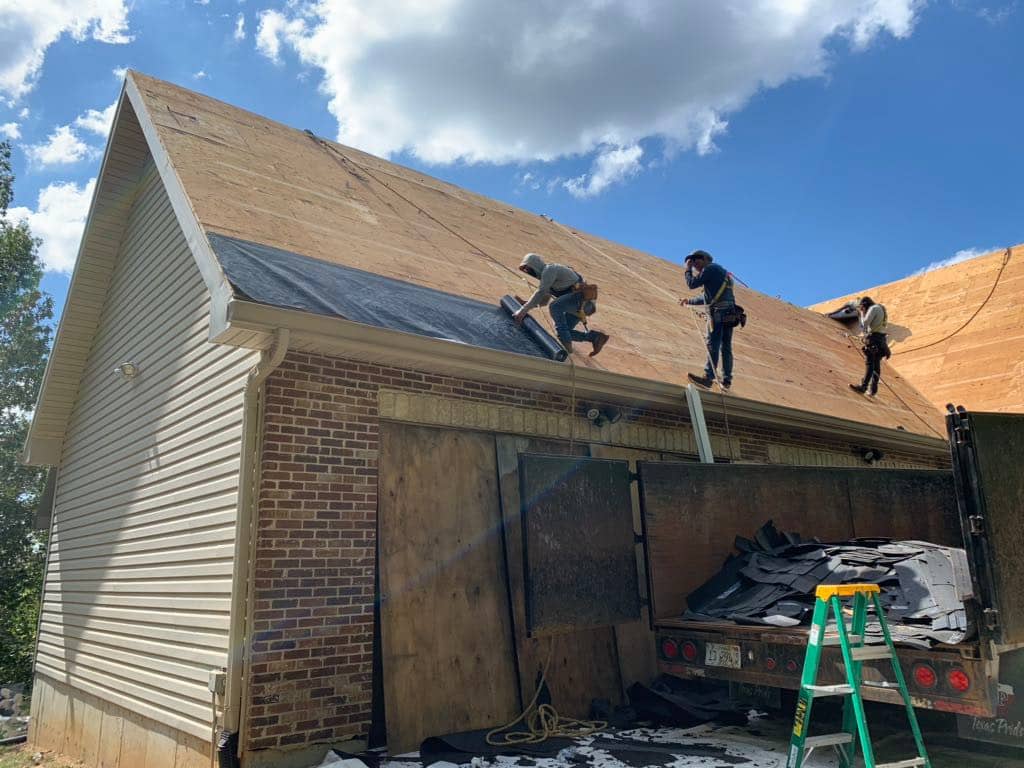 Contractors-installing-ice-and-water-shield-on-a-residential-roof